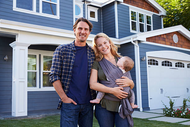 Portrait Of Family Standing Outside House